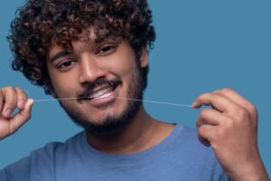 young man using floss